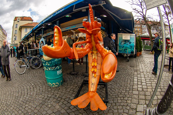 Lobster mascot at Munich seafood stall.